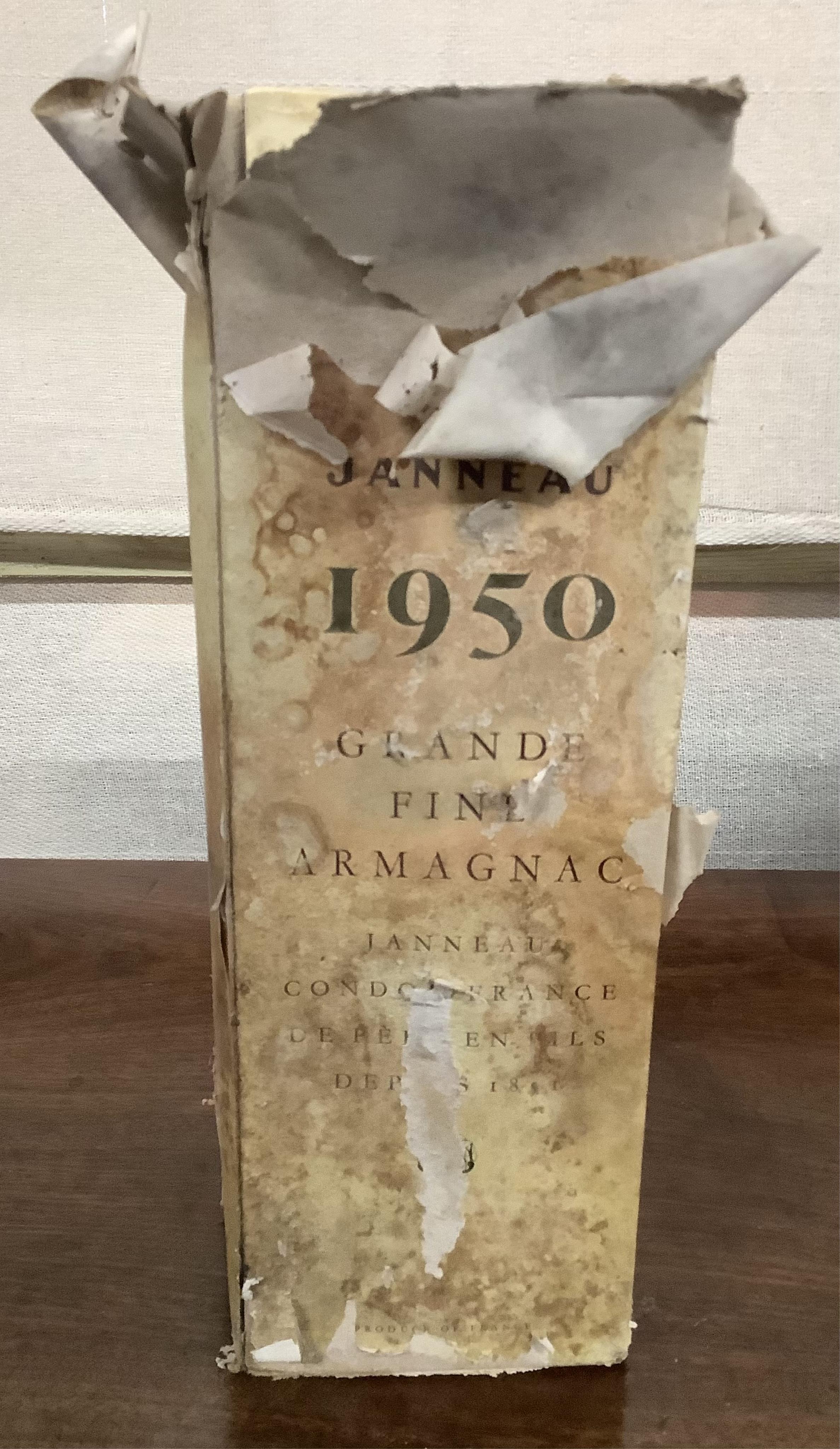 A bottle of 1950 Janneau Grande Fine Armagnac, a bottle of The Society’s Exhibition Early Landed Cognac and two bottles of Remy Martin Champagne Cognac. Condition - fair, from a local private cellar